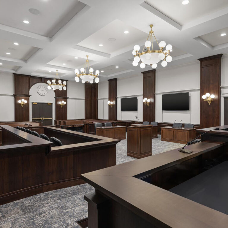 Classic chandelier and sconce lighting installed in a courtroom at Carmel Police Department