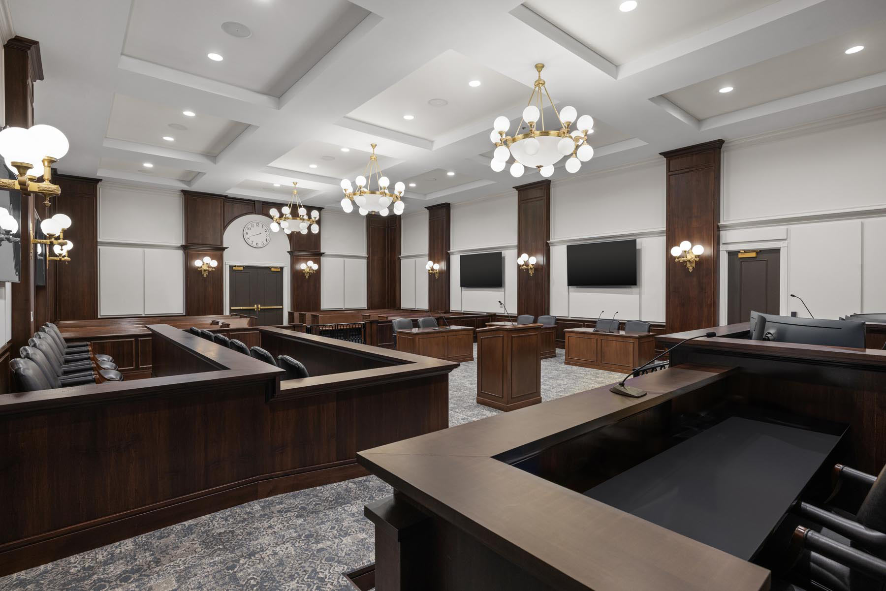 Classic chandelier and sconce lighting installed in a courtroom at Carmel Police Department